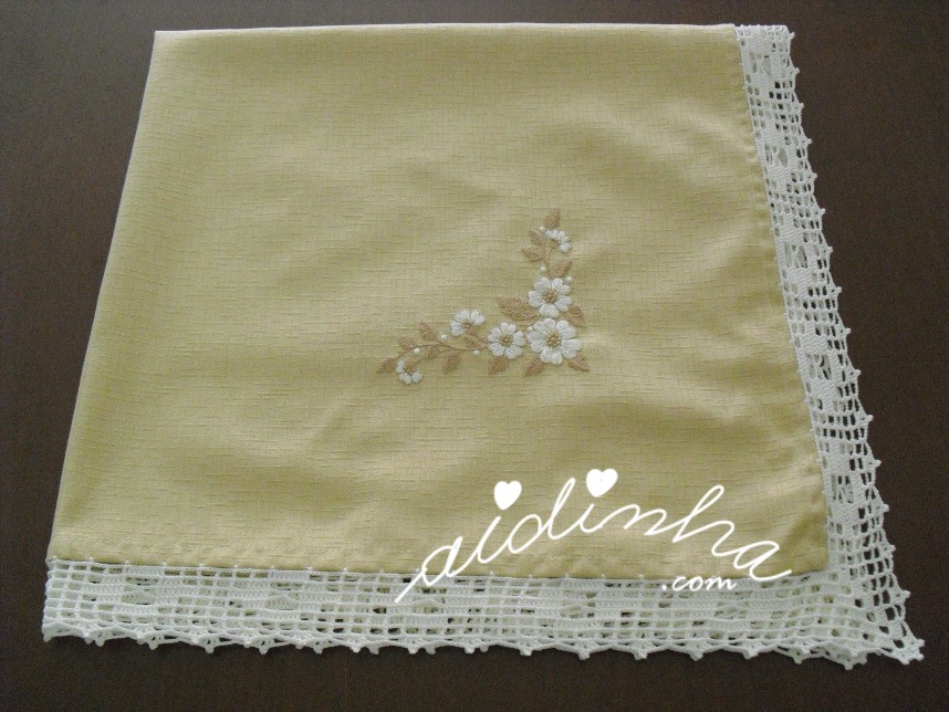 outra foto da toalha de mesa creme , com 4 bordados e crochet